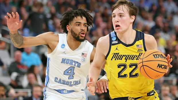 Mar 17, 2022; Fort Worth, TX, USA; Marquette Golden Eagles guard Tyler Kolek (22) dribbles the ball against North Carolina Tar Heels guard R.J. Davis (4) during the first half during the first round of the 2022 NCAA Tournament at Dickies Arena. Mandatory Credit: Kevin Jairaj-USA TODAY Sports